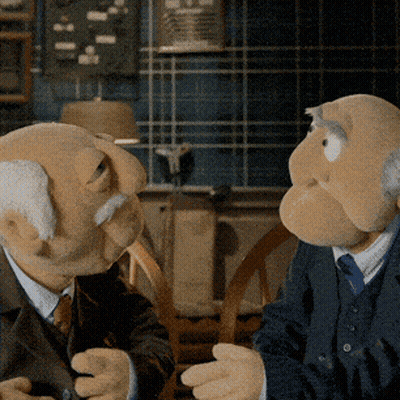 Two Muppets In Suits Talking GIF