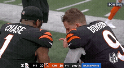 Two NFL Players Chase And Burrom Kneeling On Field GIF