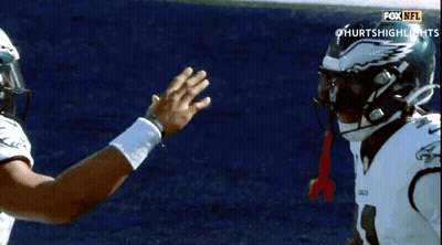Two NFL Players High Five GIF