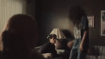 Two NFL Players High Five On Field GIF
