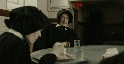 Two Nuns Sit At A Table Eating Food And Drinking Water GIF