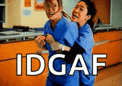 Two Nurses Are Hugging Each Other In A Hospital And The Words Idgaf Are Above Them . GIF