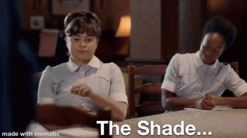 Two Nurses Are Sitting At A Table With The Words The Shade Written On The Bottom GIF