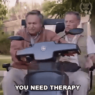 Two Older Men Are Riding A Mobility Scooter And One Of Them Is Saying You Need Therapy . GIF