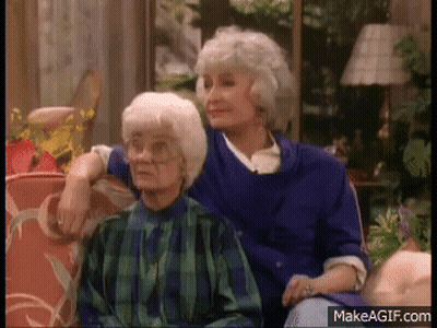 Two Older Women Sitting On A Couch GIF