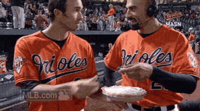 Two Orioles Baseball Players Holding A Pie GIF
