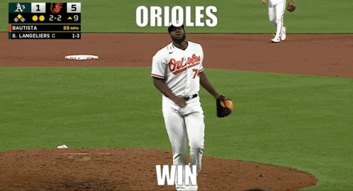 Two Orioles Baseball Players Hugging Each Other On A Field GIF