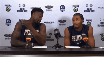Two Pelicans Players Are Sitting At A Table With Microphones GIF