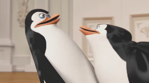 Two Penguins Are Standing Next To Each Other And Looking Up GIF