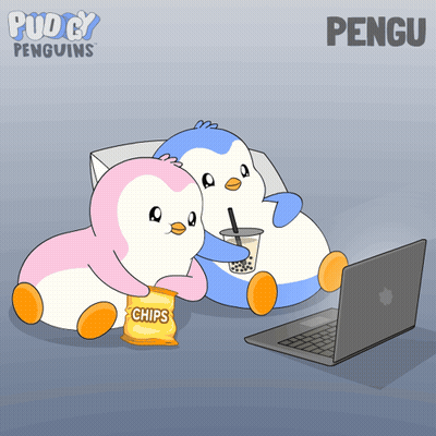 Two Penguins Sitting Next To Each Other With A Bag Of Chips In Front Of A Laptop GIF