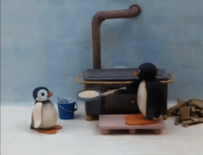 Two Penguins Standing By Stove GIF