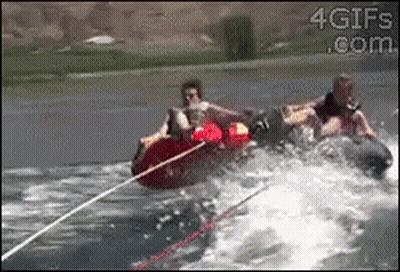 Two People Are Being Towed By A Boat In The Water And The Website 4Gifs.com Is Visible On The Bottom GIF