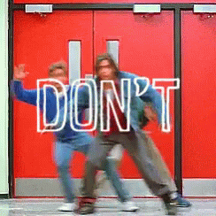 Two People Are Dancing In Front Of A Red Door That Says Don T GIF