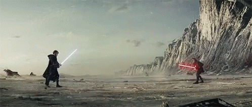 Two People Are Fighting With Lightsabers In The Desert . GIF