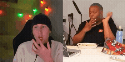 Two People Are Sitting At A Table With A Laptop And A Bowl Of Food . GIF