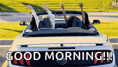 Two People Are Sitting In A Convertible Car With Their Arms In The Air And The Words Good Morning Written On The Back . GIF