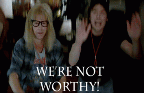 Two People Are Sitting Next To Each Other With The Words " We 'Re Not Worthy " On The Bottom GIF