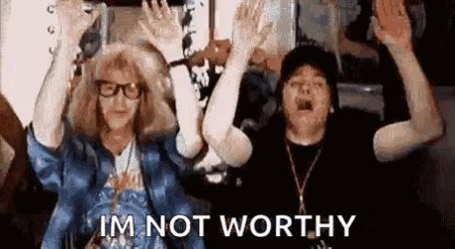 Two People Are Standing Next To Each Other With Their Arms In The Air And The Words `` I 'M Not Worthy '' . GIF