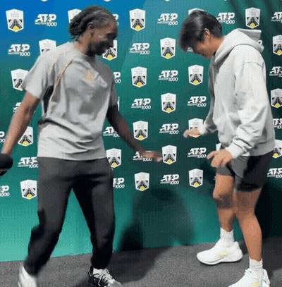 Two People Dancing In Front Of ATP 1000 Wall GIF