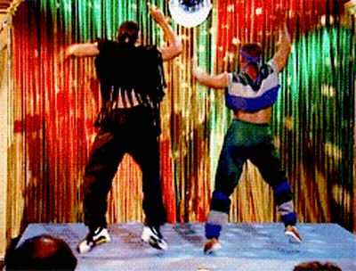 Two People Dancing In Front Of Disco Ball GIF