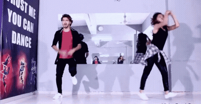 Two People Dancing In Front Of Just Me You Can Dance Sign GIF