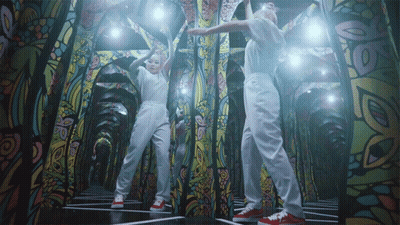 Two People Dancing With Stained Glass Wall GIF