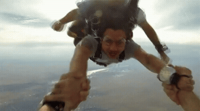Two People Holding Hands In Air GIF
