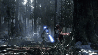 Two People Holding Lightsabers In Forest GIF