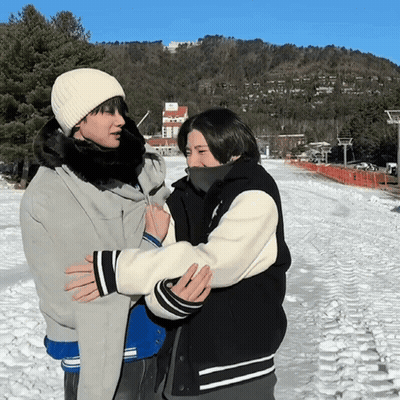 Two People Hugging In Snow GIF