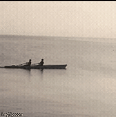 Two People In A Boat In Ocean GIF