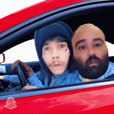 Two People In A Red Car With A Snapchat Logo On The Side GIF
