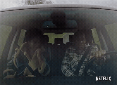 Two People In Car With Netflix Logo GIF
