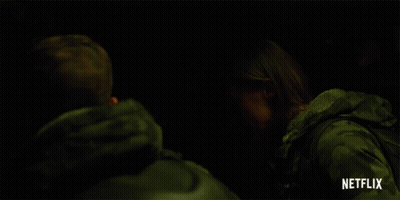 Two People In Dark Room With Netflix Logo GIF