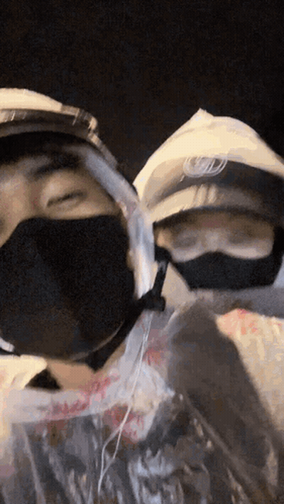 Two People In Face Masks One With Helmet GIF