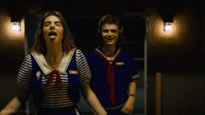 Two People In Sailor Outfits Are Laughing And Spellbooked Is Visible In The Bottom Right Corner GIF