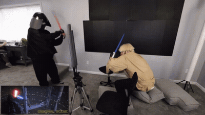 Two People In Star Wars Costumes Fighting With Lightsabers GIF