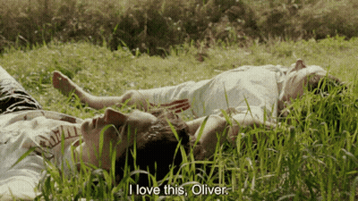 Two People Laying In The Grass With The Words " I Love This Oliver " On The Bottom GIF