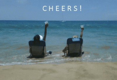 Two People On Beach Feet In Air Cheers GIF