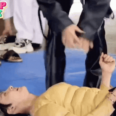 Two People On Blue Mat Hand Over Head GIF