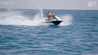 Two People Riding A Jet Ski In The Ocean With The Hashtag #Ayo GIF
