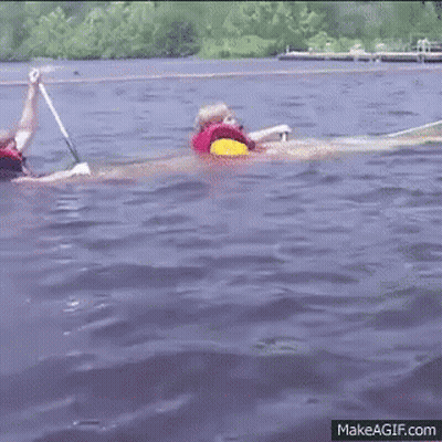 Two People Rowing Boat In Life Jackets GIF