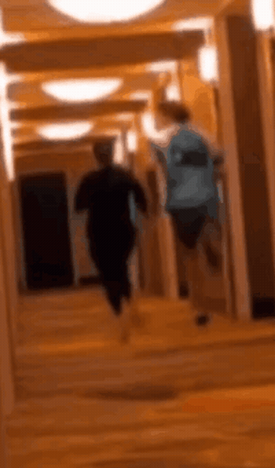 Two People Running Down Stairs GIF