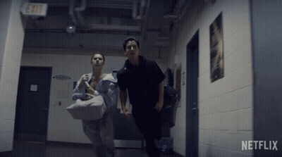 Two People Running In Hallway With Netflix Logo GIF