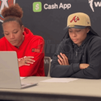 Two People Sitting At Table With Laptop And Cash App Logo GIF