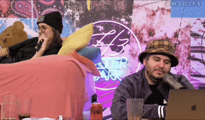 Two People Sitting In Front Of 43 Ster Park Sign GIF