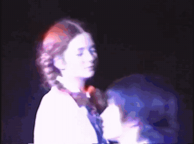 Two People Standing In Dark Room GIF