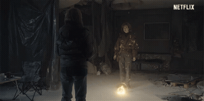 Two People Standing In Room With Netflix Logo GIF