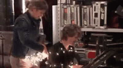 Two People Standing In Room GIF