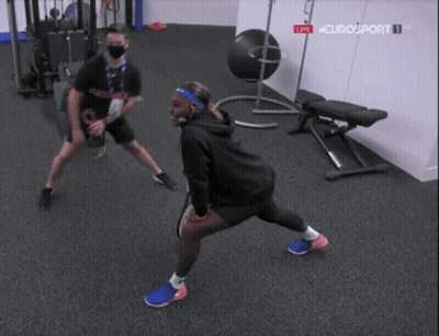 Two People Stretching In Gym GIF