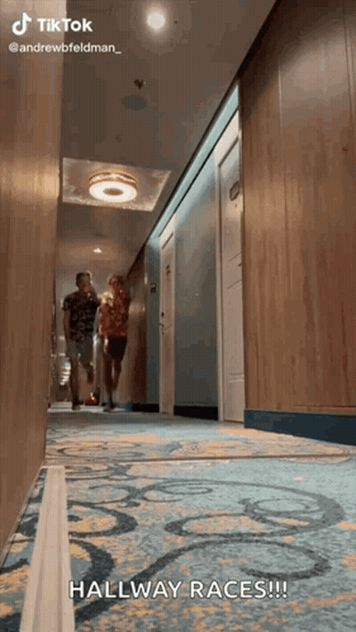 Two People Walking Down Hallway Hallway Races GIF